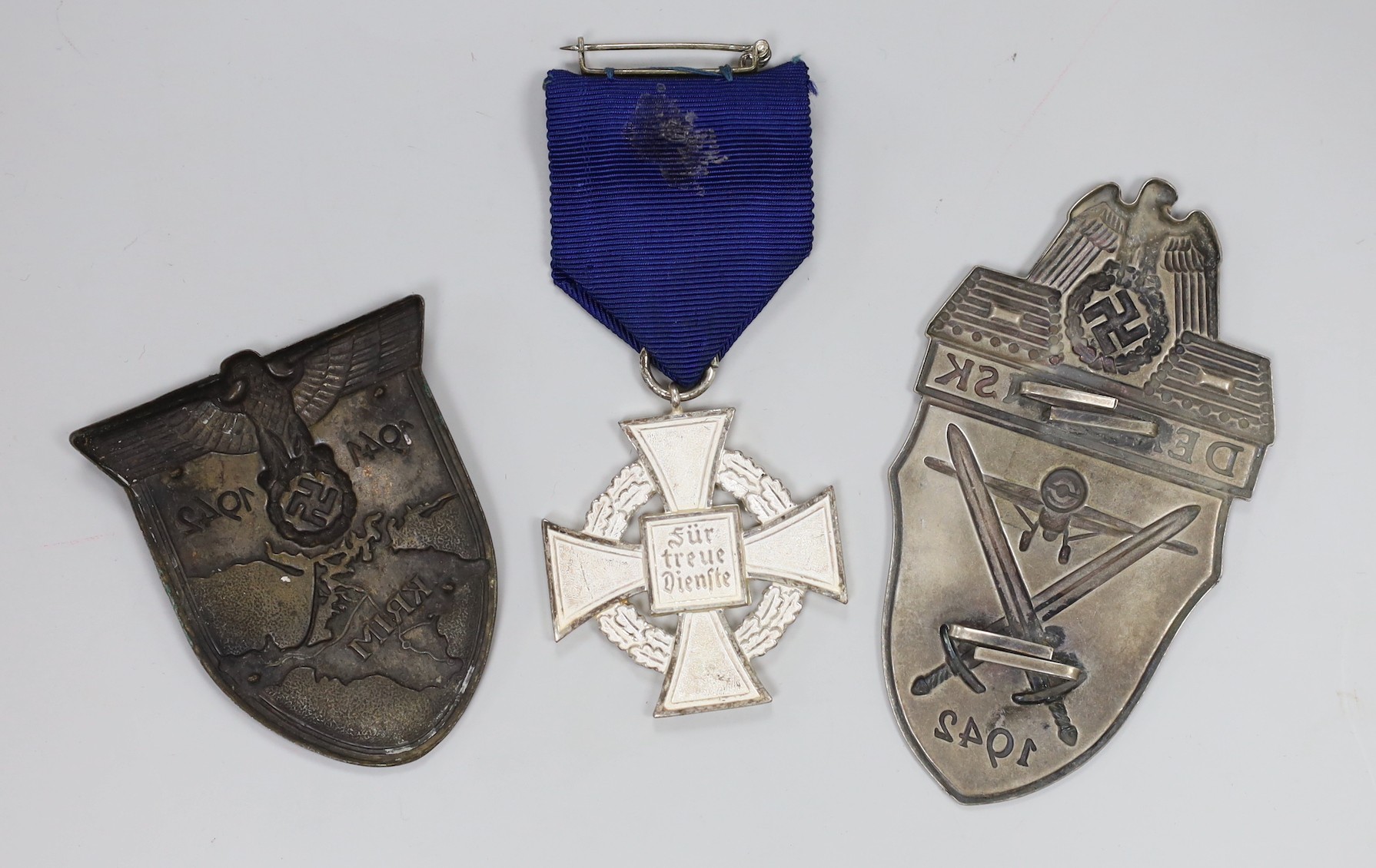 German Third Reich Demanjsk and Luftwaffe Krim badges and a 25 year's faithful service medal